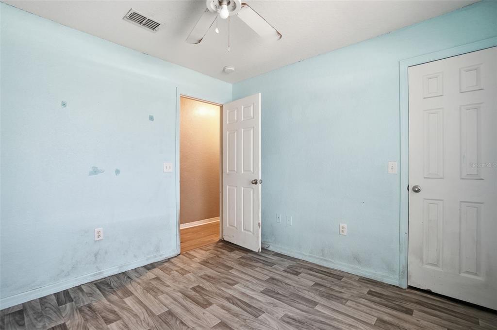 10490 Mayflower Road Spring Hill, FL 34608 - Photo 24 of 35 a view of an empty room with wooden floor