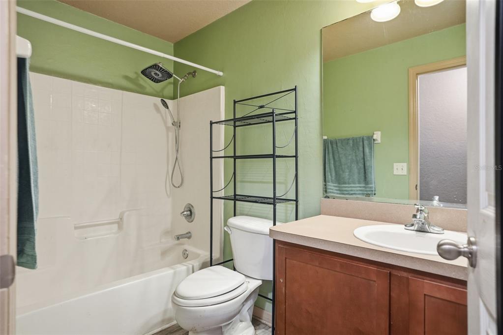 10490 Mayflower Road Spring Hill, FL 34608 - Photo 29 of 35 a bathroom with a sink toilet and shower