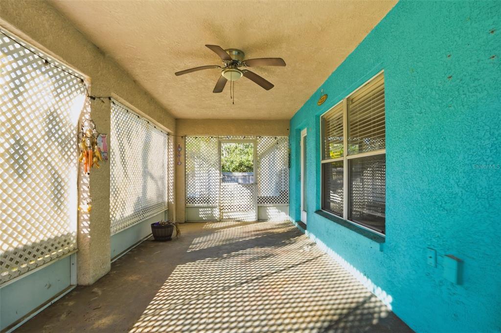 10490 Mayflower Road Spring Hill, FL 34608 - Photo 32 of 35 a bedroom with a bed and a large window with balcony view