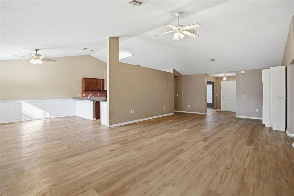 10490 Mayflower Road Spring Hill, FL 34608 - Photo 5 of 35 a view of empty room with wooden floor