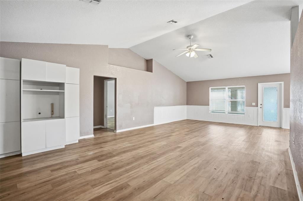 10490 Mayflower Road Spring Hill, FL 34608 - Photo 7 of 35 a view of empty room with wooden floor and fan