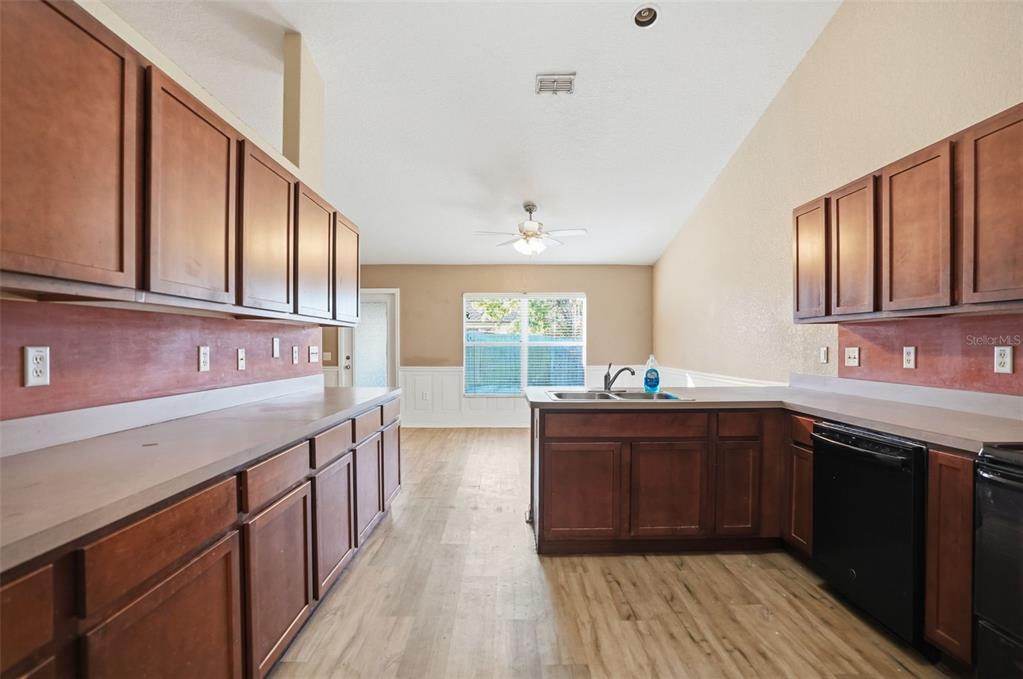 10490 Mayflower Road Spring Hill, FL 34608 - Photo 8 of 35 a kitchen with a sink and wooden cabinets