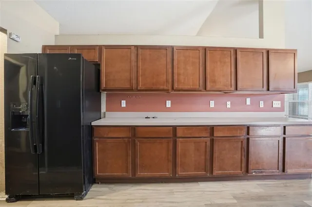 a kitchen with a sink cabinets and wooden floor