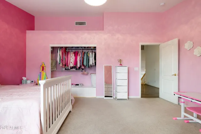 a bedroom with a bed and a ceiling fan