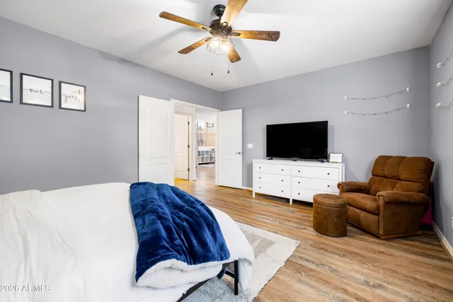 a bathroom with a granite countertop sink a toilet a mirror and shower
