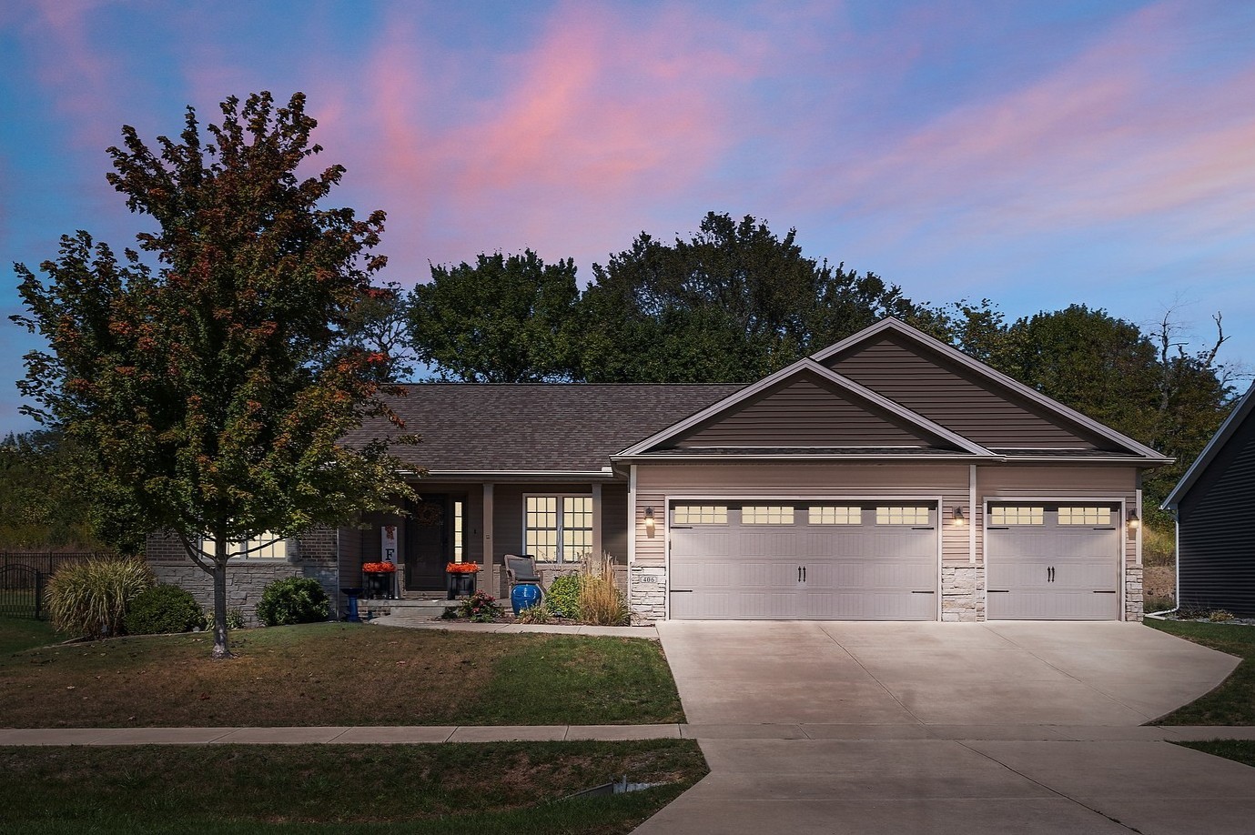 a front view of a house with a yard and garage