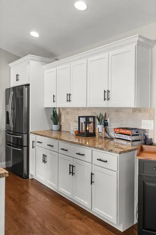 a view of a workspace with furniture and wooden floor