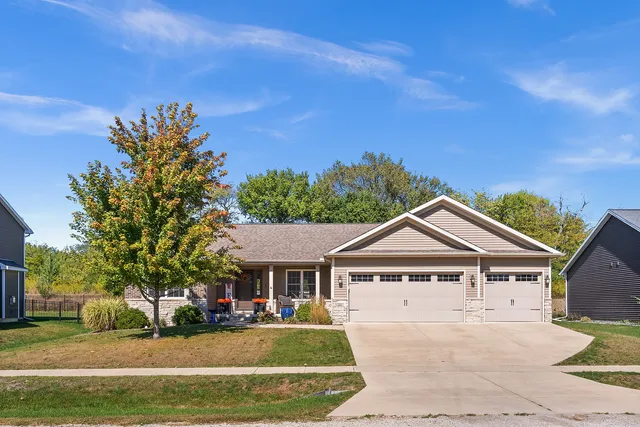 a view of a house with a big yard and large trees