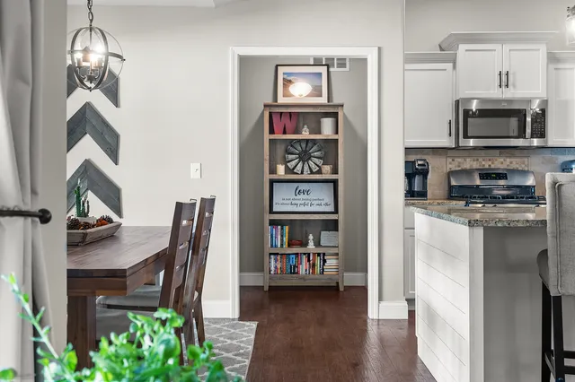 a bathroom with a granite countertop double vanity sink and a mirror