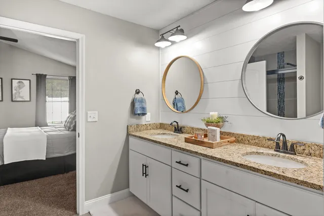 a bedroom with a bed and a couch next to a window