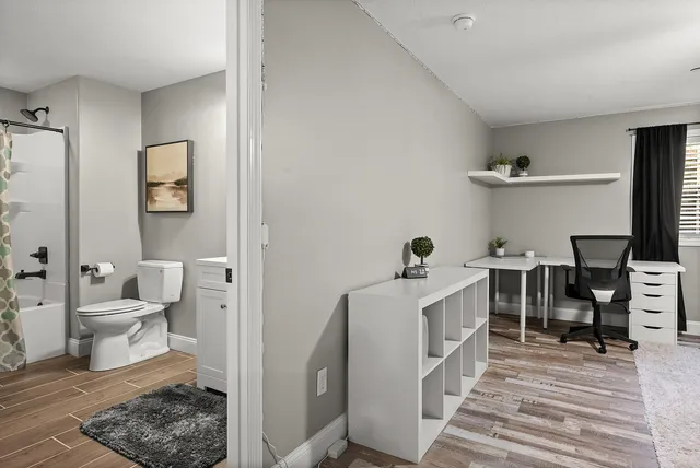 an aerial view of residential houses with outdoor space and parking