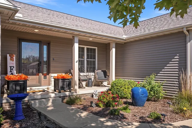 a front view of a house with outdoor seating
