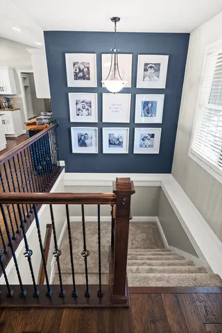a kitchen with stainless steel appliances kitchen island granite countertop a table chairs and a refrigerator