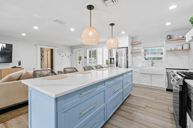 a kitchen with a table chairs sink and cabinets
