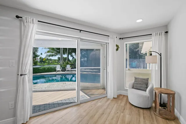a bedroom with a bed next to a window