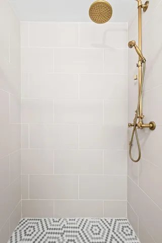 a bedroom with a balcony a bed and a large window