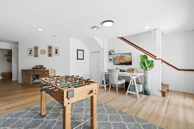 a bed sitting in a spacious bedroom next to a window