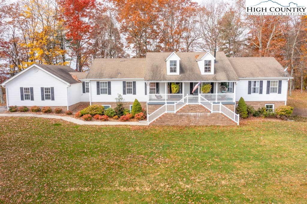 8877 Glade Valley Road Ennice, NC 28623 - Photo 1 of 49 a front view of house with yard and trees around