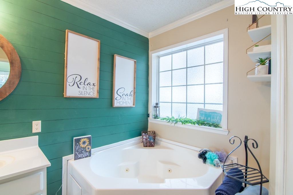 8877 Glade Valley Road Ennice, NC 28623 - Photo 13 of 49 a bathroom with a sink and a large window
