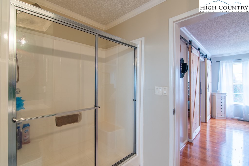 8877 Glade Valley Road Ennice, NC 28623 - Photo 14 of 49 a bathroom with a glass shower door
