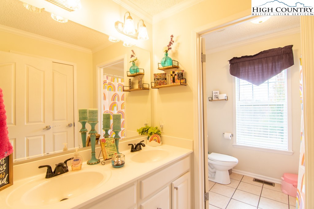 8877 Glade Valley Road Ennice, NC 28623 - Photo 22 of 49 a bathroom with a sink double vanity and a mirror