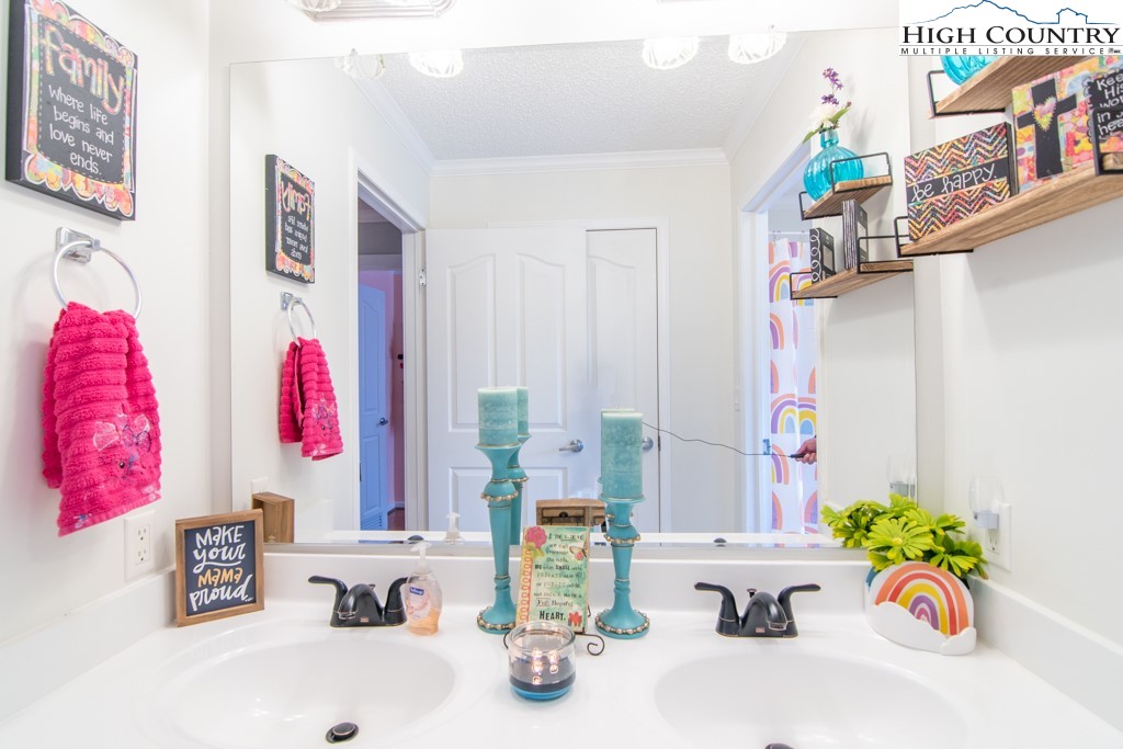 8877 Glade Valley Road Ennice, NC 28623 - Photo 23 of 49 a bathroom with a sink mirror and window
