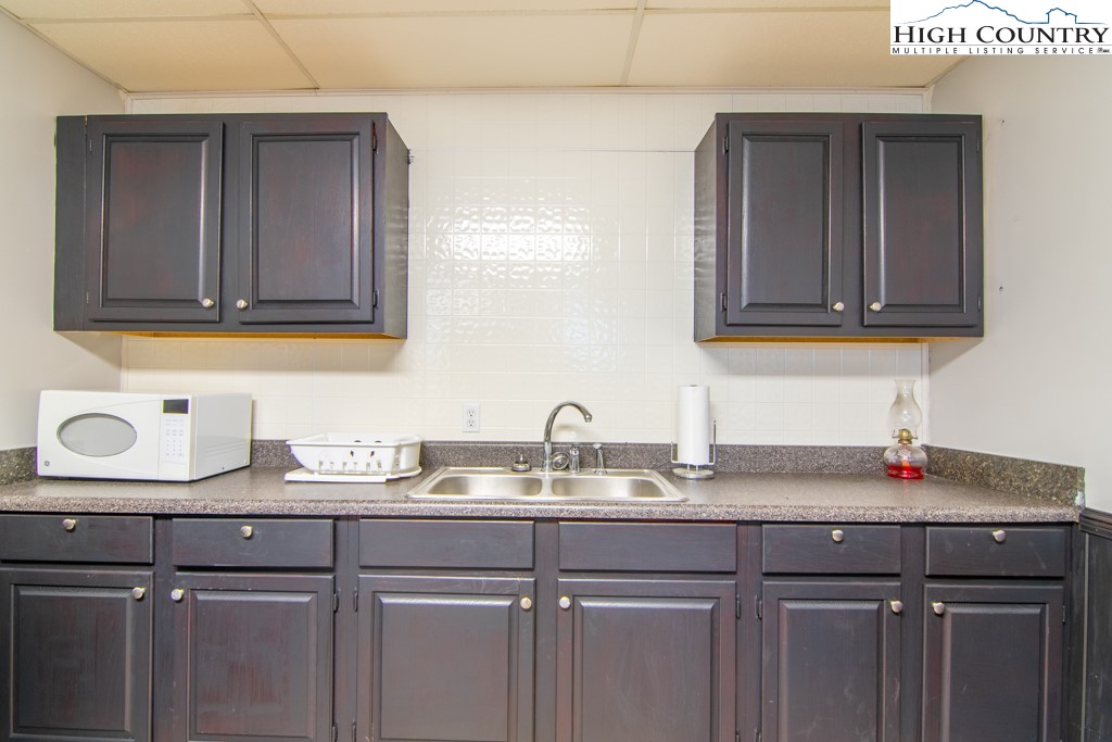 8877 Glade Valley Road Ennice, NC 28623 - Photo 36 of 49 a kitchen with sink and cabinets