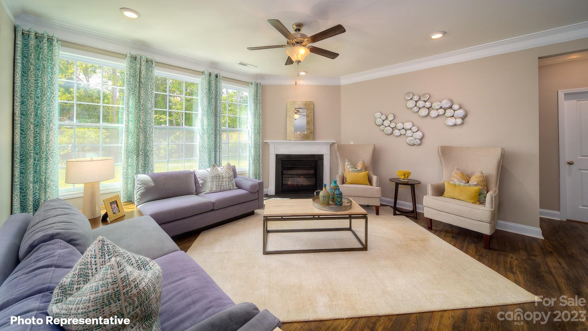 310 Streamwood Road Troutman, NC 28166 - Photo 7 of 35 a living room with furniture and a fireplace