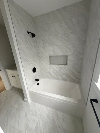 a bathroom with double vanity sinks and two mirror