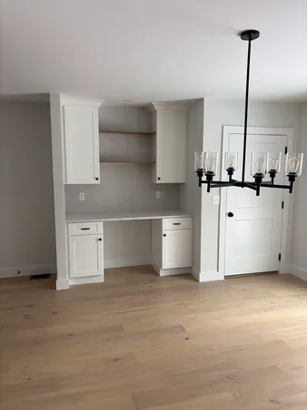a kitchen with stainless steel appliances granite countertop a stove and a white cabinets