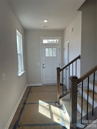 a view of entryway and hall with wooden floor