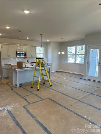 a view of a kitchen with a sink and cabinets