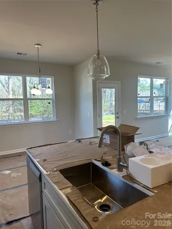 a kitchen with a stove a sink and a window