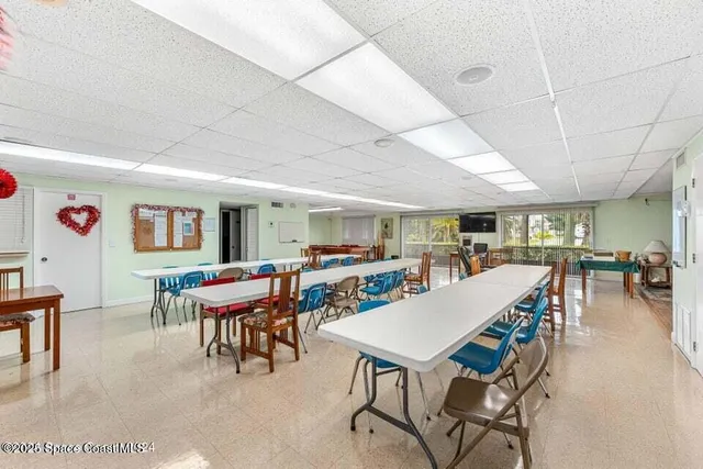 a room with pool table and wooden floor