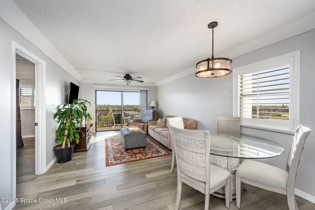 a view of a dining room with furniture wooden floor and a chandelier