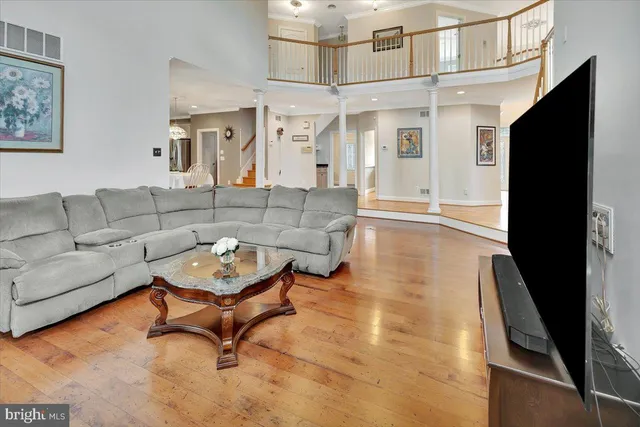 a bathroom with a toilet a sink a mirror and a window