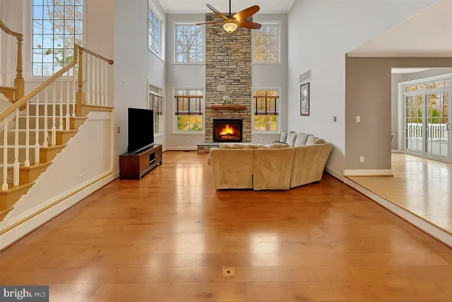a view of a hallway with wooden floor and stairs