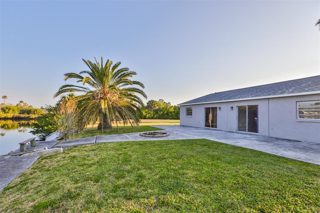 9925 Grace Drive Port Richey, FL 34668 - Photo 4 of 14 a house with swimming pool in front of it