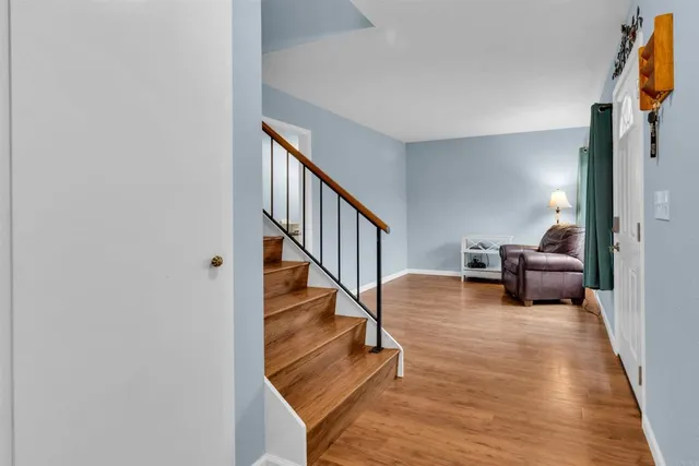 a living room with furniture and stairs