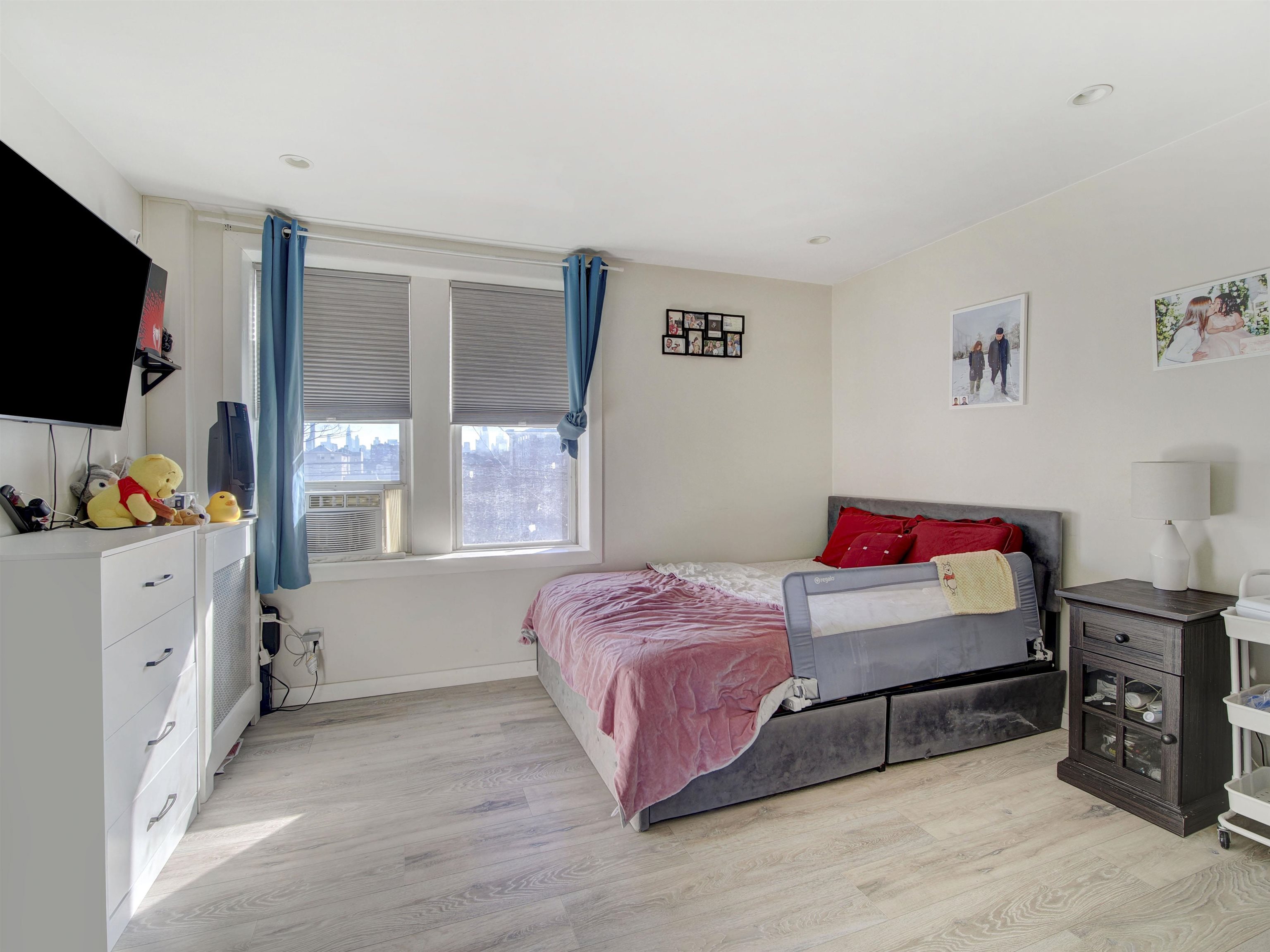 201 45th Street, Unit B4 Union City, NJ 07087 - Photo 3 of 8 a bedroom with a bed and a flat screen tv