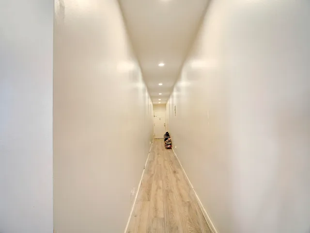 a view of a hallway with a white door