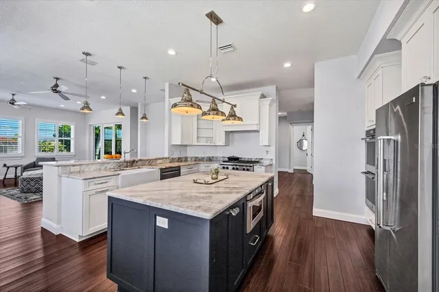 a kitchen with a stove a refrigerator and a sink