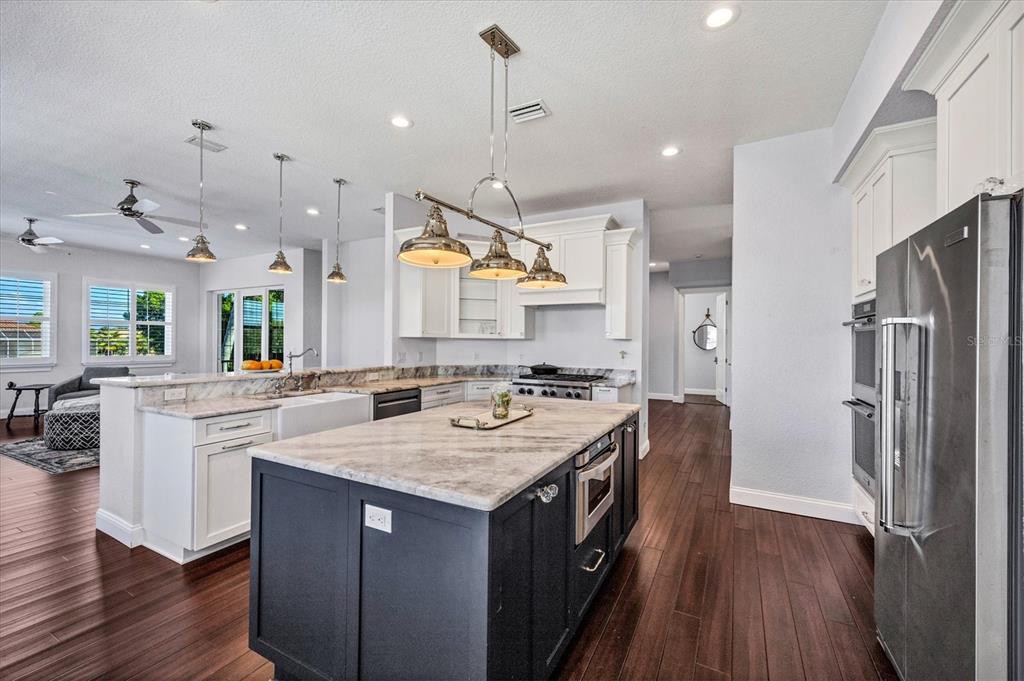 10050 Creekside Drive Placida, FL 33946 - Photo 13 of 52 a kitchen with a sink a counter top space stainless steel appliances and wooden floor