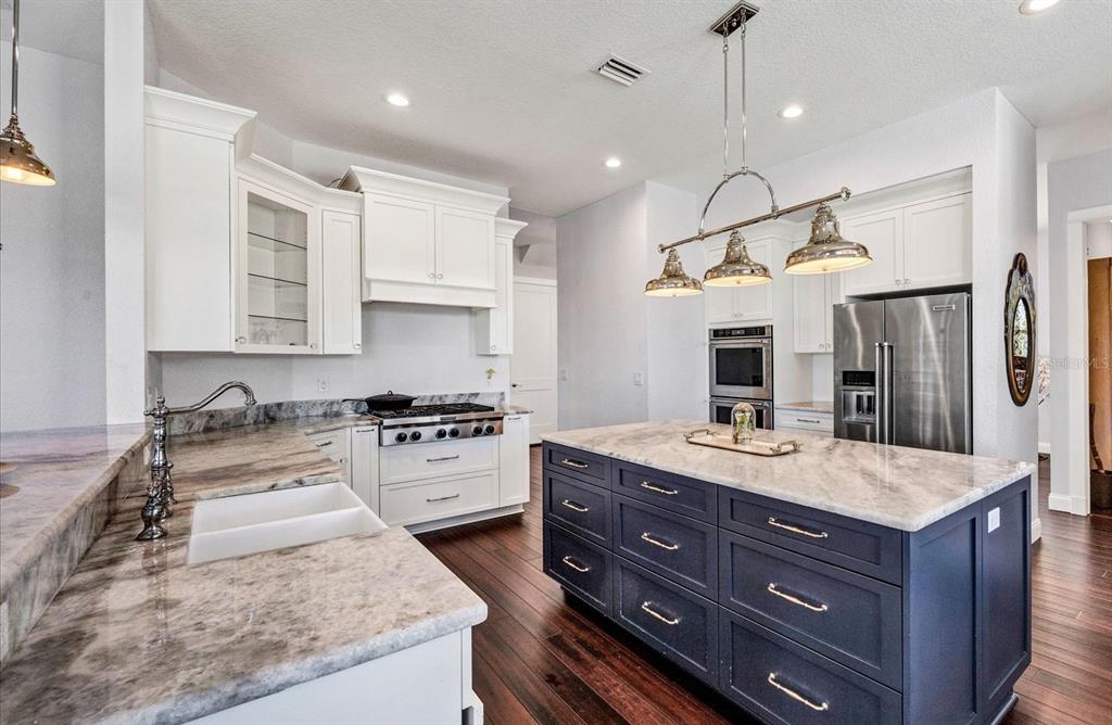 10050 Creekside Drive Placida, FL 33946 - Photo 14 of 52 a kitchen with a stove a refrigerator and a sink