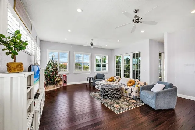 a view of an empty room with wooden floor fireplace and a window
