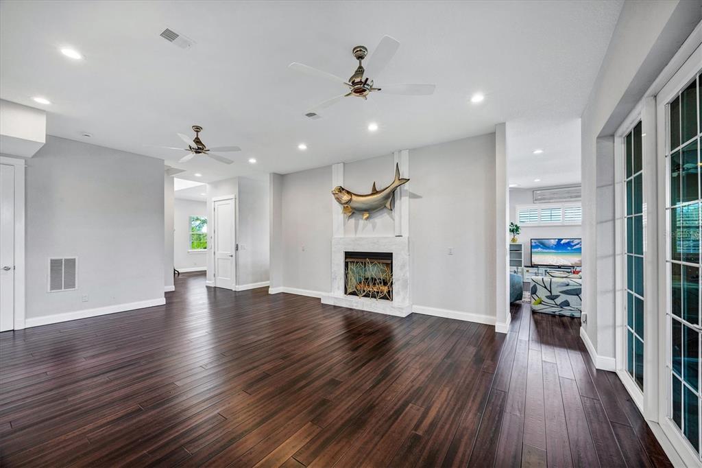 10050 Creekside Drive Placida, FL 33946 - Photo 19 of 52 a view of a livingroom with wooden floor and a kitchen