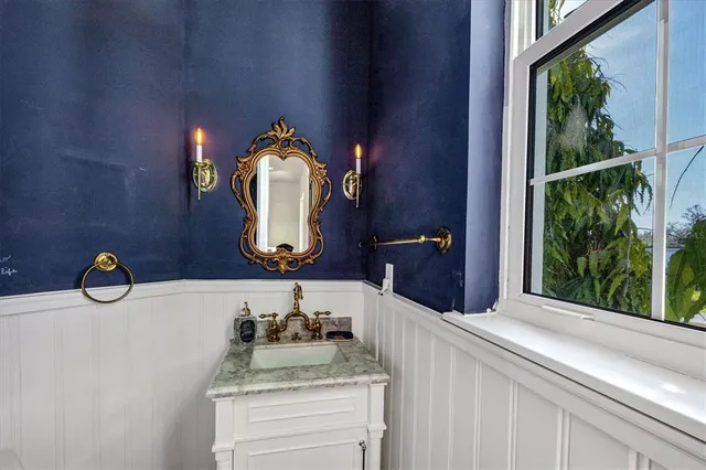 a bedroom with a bed wooden floor and windows