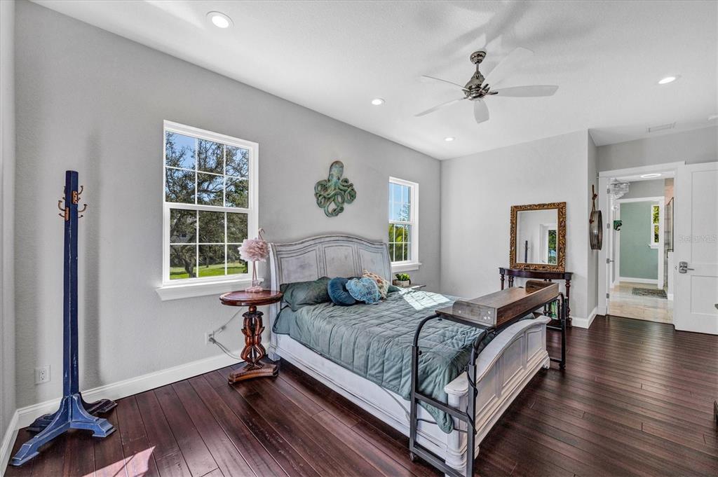 10050 Creekside Drive Placida, FL 33946 - Photo 24 of 52 a bedroom with a bed wooden floor and window