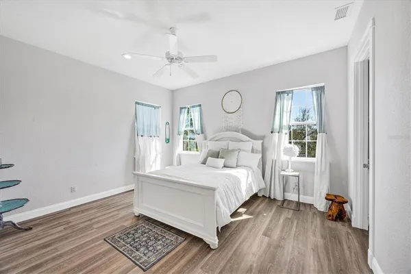 a bathroom with a granite countertop sink a mirror and a toilet