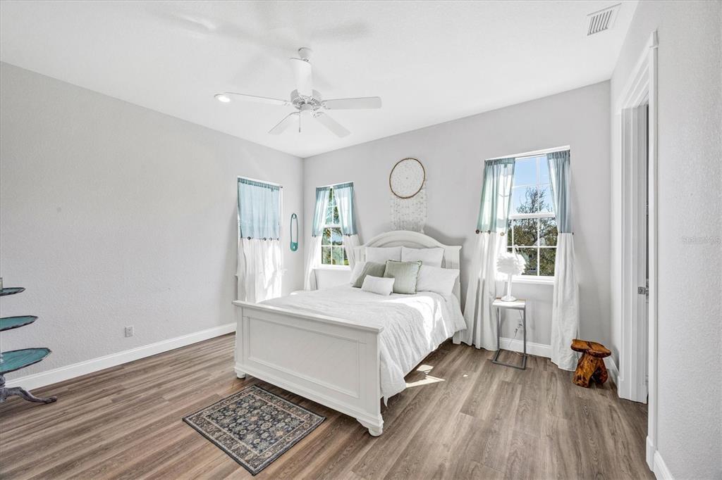 10050 Creekside Drive Placida, FL 33946 - Photo 29 of 52 a bedroom with a bed and wooden floor